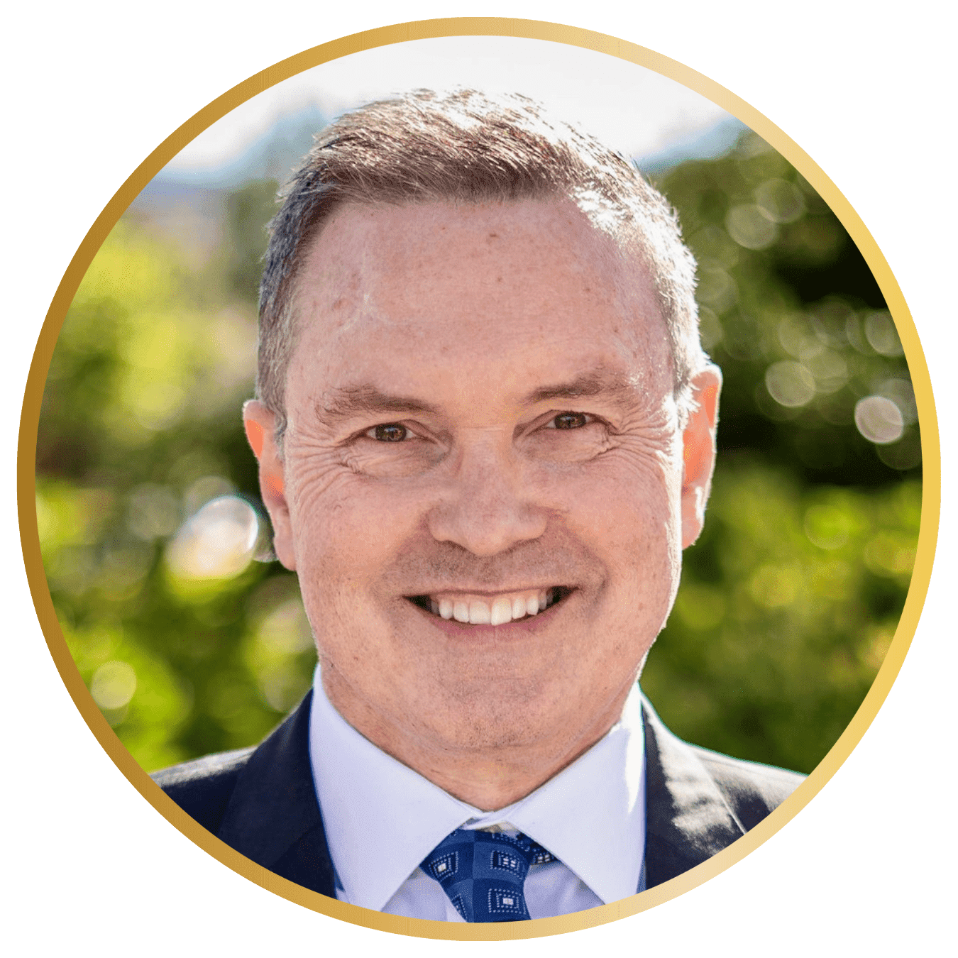 Len Gross Feature Headshot in round gold frame